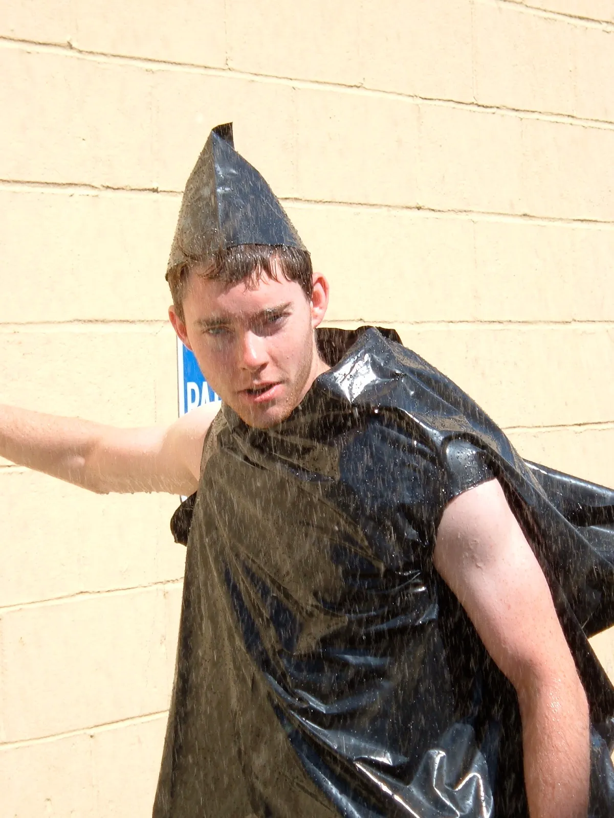 A person wearing black plastic material in the rain.